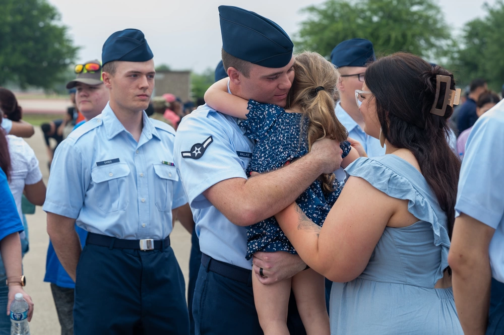 Family embracing during a BMT graduation celebration