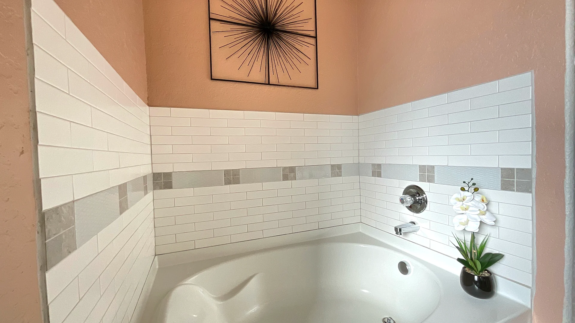 Bathtub with white subway tile at Glampstead Retreat